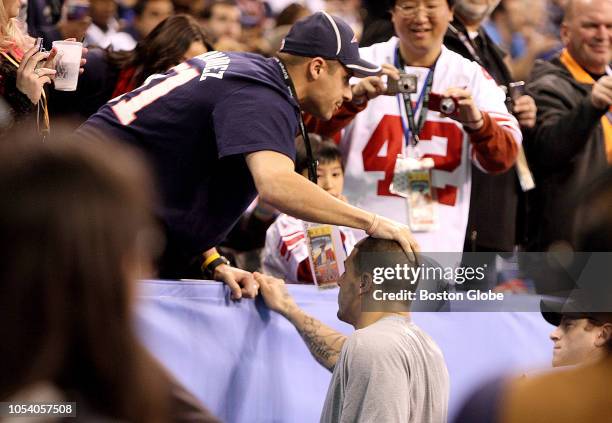 Patriots player Aaron Hernandez greets his brother Jonathan during the pre-game warm-up before the Super Bowl in Lucas Oil Stadium. New England...