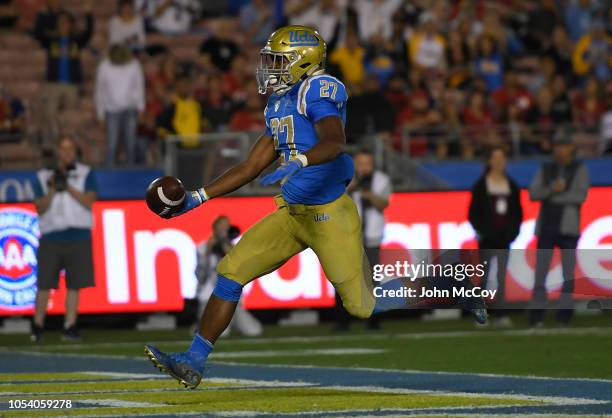 Joshua Kelley of the UCLA Bruins scores a touchdown against Utah Utes in the first half at the Rose Bowl on October 26, 2018 in Pasadena, California.