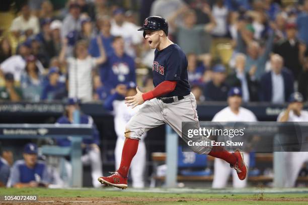 Brock Holt of the Boston Red Sox scores a thirteenth inning run against the Los Angeles Dodgers in Game Three of the 2018 World Series at Dodger...