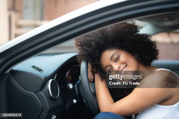 woman driver portrait at car interior - pride - new car stock pictures, royalty-free photos & images