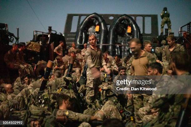 Commando, Royal Marines relax on a marine landing craft as they head from RFA Lyme Bay on a night time raid as part of exercise 'Saif Sareea 3' on...