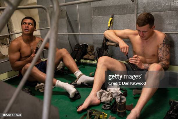 Men from 40 Commando, Royal Marines service their weapons on board HMS Albion during exercise 'Saif Sareea 3' on October 24, 2018 in the Arabian Sea,...