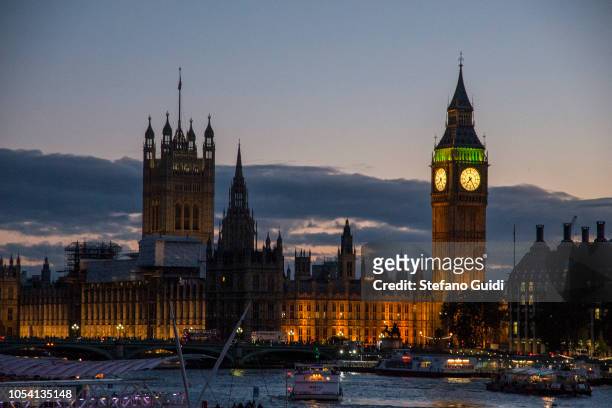 Silhouette at sunset of the Palace of Westminster is the meeting place of the House of Commons and the House of Lords, the two houses of the...