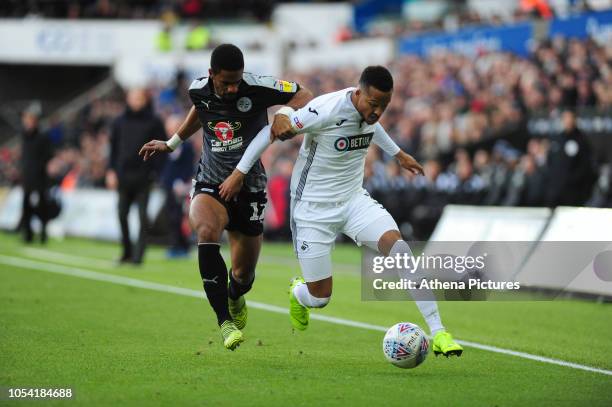 Garath McCleary of Reading vies for possession with Martin Olsson of Swansea City during the Sky Bet Championship match between Swansea City and...