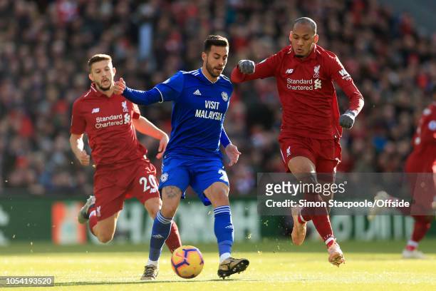 Victor Camarasa of Cardiff battles with Adam Lallana of Liverpool and Fabinho of Liverpool during the Premier League match between Liverpool and...