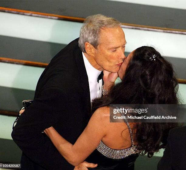 Clint Eastwood, winner Best Director and Best Picture for "Million Dollar Baby", kisses Dina Eastwood