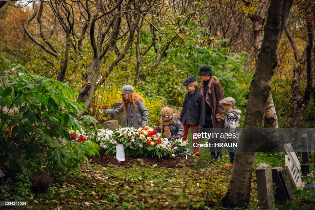 Family visiting grave of deceased loved one.