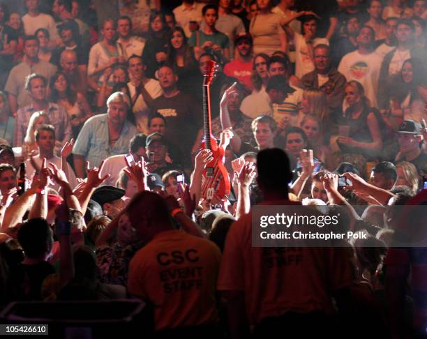 Dave Grohl's guitar rises from the crowd after palying from the audience