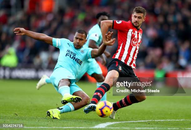 Salomon Rondon of Newcastle United shoots under pressure from Jack Stephens of Southampton during the Premier League match between Southampton FC and...