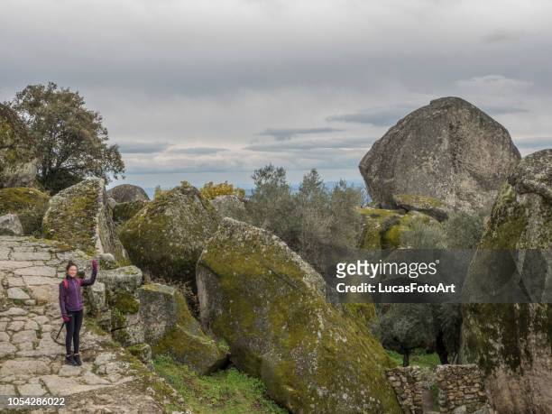 hiker woman posing in landscape with granitic rocks - monsanto stock pictures, royalty-free photos & images