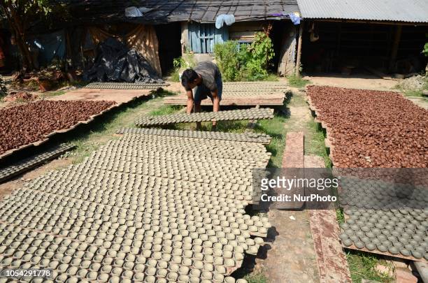 Indian worker prepares Diyas or Earthen Lamp at a workshop for the upcoming Diwali festival on the outskirts of Kolkata , India on Saturday , 27th...
