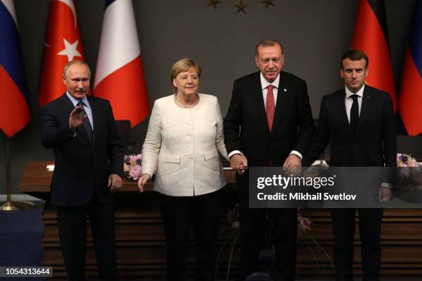 Russian President Vladimir Putin, German Chancellor Angela Merkel, Turkish President Recep Tayyip Erdogan and French President Emmanuel Macron hold...