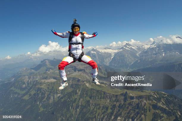 sky diver falls through mid-air - wing suit stock pictures, royalty-free photos & images