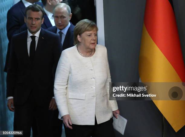 German Chancellor Angela Merkel , Russian President Vladimir Putin and French President Emmanuel Macron enter the hall during their joint press...