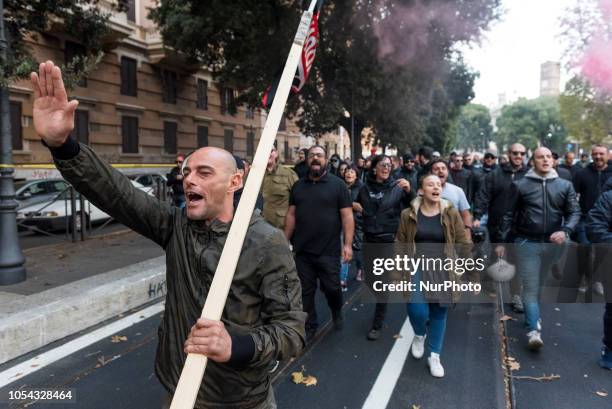 Forza Nuova militants do the Nazi salute during an unauthorised march after a demonstration organised by the far-right group near Romes San Lorenzo...
