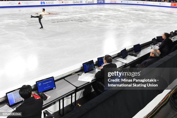 Judges watch as Kevin Aymoz of France performs his routine on day two during the ISU Grand Prix of Figure Skating Skate Canada International at Place...