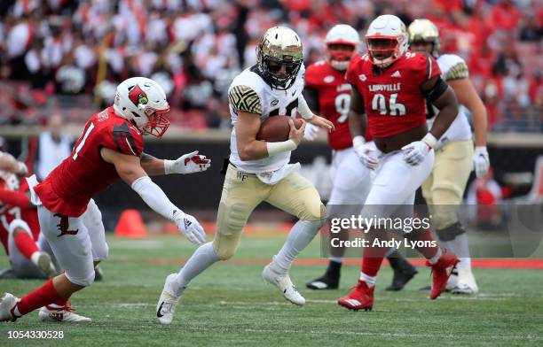 Sam Hartman of the Wake Forest Demon Deacons runs with the ball against the Louisville Cardinals on October 27, 2018 in Louisville, Kentucky.