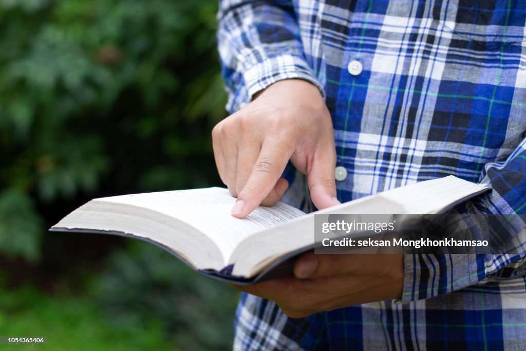 Man reading from the holy bible,