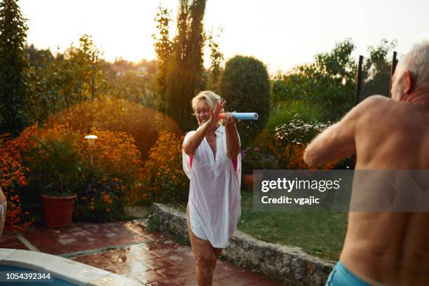 family water fight - spraying water stock pictures, royalty-free photos & images