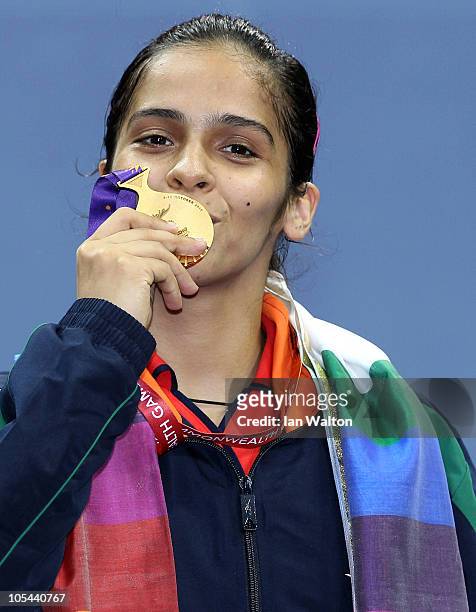 Saina Nehwal of India celebrates winning a gold medal in the women's singles badminton at Vijay Chowk during day eleven of the Delhi 2010...
