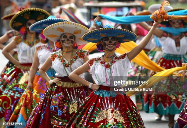 People take part in the Day of the Dead parade in Mexico City on October 27, 2018.