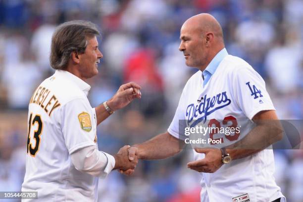 Dennis Eckersley and Kirk Gibson shake hands on the mound after Eckersley threw out the ceremonial first pitch to Gibson prior to in Game Four of the...