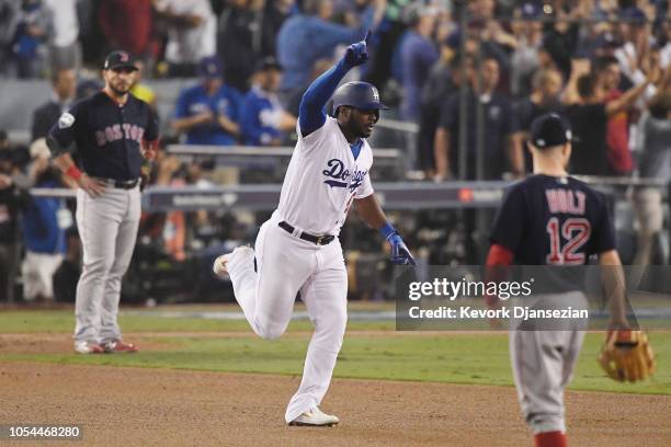 Yasiel Puig of the Los Angeles Dodgers celebrate on his way to second hase after hitting a three-run home run in the sixth inning of Game Four of the...