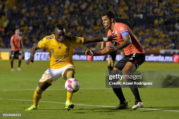 Julian Quinones of Tigres fights for the ball with Francisco Rodriguez of Lobos during the 14th round match between Tigres UANL and Lobos BUAP as...
