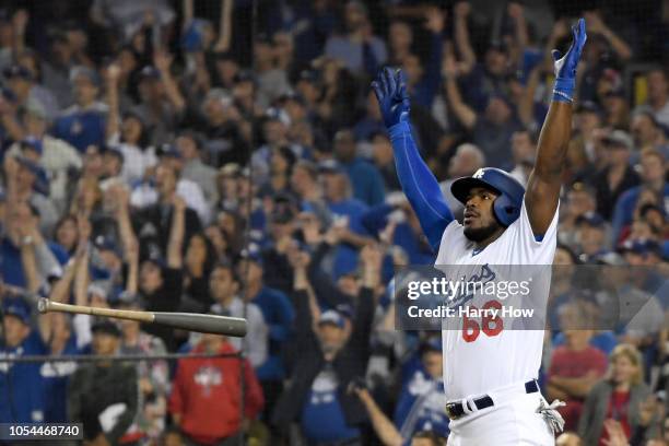 Yasiel Puig of the Los Angeles Dodgers tosses his bat aside and celebrates as his hit goes for a three-run home run to left field in the sixth inning...