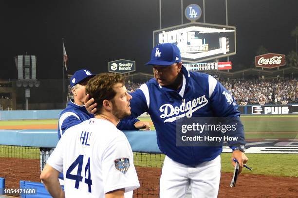 Manager Dave Roberts of the Los Angeles Dodgers talks with pitcher Rich Hill after taking Hill out of the game in the sixth inning of Game Four of...