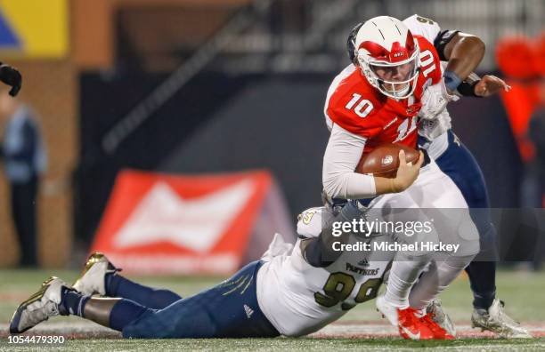 Steven Duncan of the Western Kentucky Hilltoppers runs the ball and is tackled from behind by Jermaine Sheriff of the Fiu Golden Panthers on October...