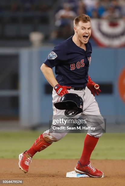 Brock Holt of the Boston Red Sox reacts at second base after hitting a one-out double to left field in the ninth inning of Game Four of the 2018...