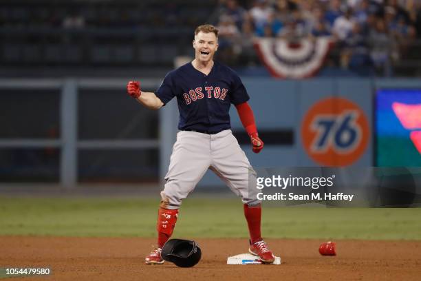 Brock Holt of the Boston Red Sox reacts at second base after hitting a one-out double to left field in the ninth inning of Game Four of the 2018...