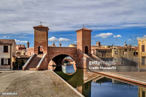 view of the trepponti bridge and canal in comacchio, italy - ferrara foto e immagini stock