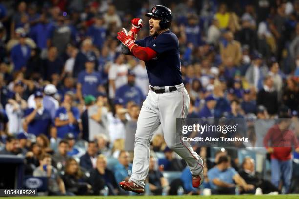 Steve Pearce of the Boston Red Sox reacts to hitting a game-tying solo home run in the eighth inning during Game 4 of the 2018 World Series against...