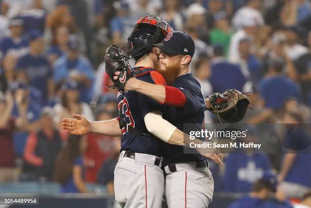 Catcher Blake Swihart and pitcher Craig Kimbrel of the Boston Red Sox congratulate one another after defeating the Los Angeles Dodgers 9-6 in Game...