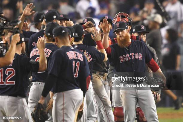 Closing pitcher Craig Kimbrel of the Boston Red Sox celebrates with his teammates after they defeated the Los Angeles Dodgers 9-6 in Game Four of the...