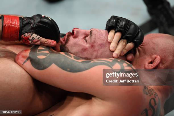 Anthony Smith secures a rear choke submission against Volkan Oezdemir of Switzerland in their light heavyweight bout during the UFC Fight Night event...