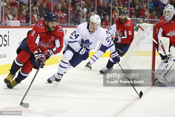 Alex Ovechkin of the Washington Capitals skates past Kasperi Kapanen of the Toronto Maple Leafs during the first period at Capital One Arena on...