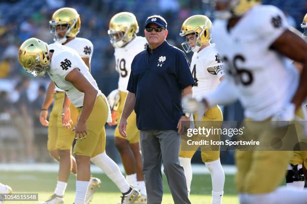 Notre Dame head coach Brian Kelly runs drills for pregame warmups