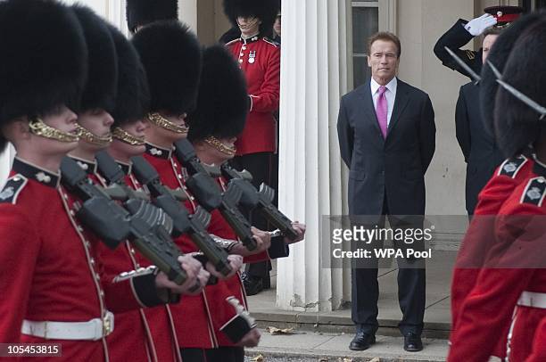 California Governor Arnold Schwarzenegger and Britsh Prime Minister David Cameron watch troops at Wellington Barracks on October 14, 2010 in London,...