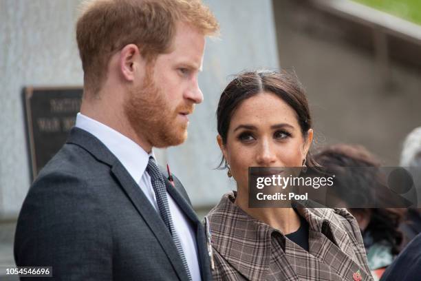 Prince Harry, Duke of Sussex and Meghan, Duchess of Sussex lay ferns and a wreath at the tomb of the Unknown Warrior at the newly unveiled UK war...