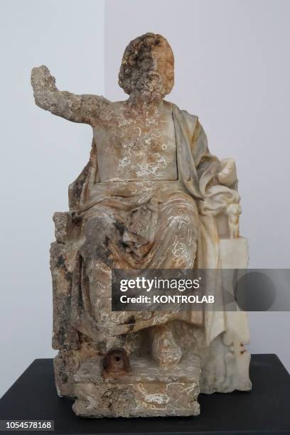 The statue of 'Zeus Enthroned' shows on October 27 to Baia, near Naples, after being exhibited at the Getty Museum in Los Angeles from 1992 until...