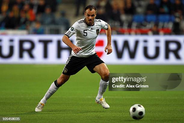 Heiko Westermann of Germany runs with the ball during the EURO 2012 group A qualifier match between Kazakhstan and Germany at the Astana Arena on...