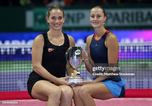 Kristina Mladenovic of France and Timea Babos of Hungary pose with the Martina Navratilova trophy after winning their match against Barbora...