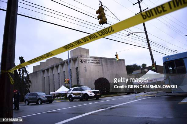 Police tape is viewed around the area on October 28, 2018 outside the Tree of Life Synagogue after a shooting there left 11 people dead in the...