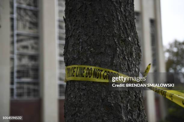 Police tape is viewed on October 28, 2018 outside the Tree of Life Synagogue after a shooting there left 11 people dead in the Squirrel Hill...