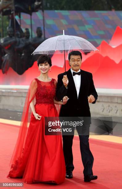 Actress Angie Chiu and husband Melvin Wong pose on the red carpet during the closing ceremony of the 5th Silk Road International Film Festival at the...