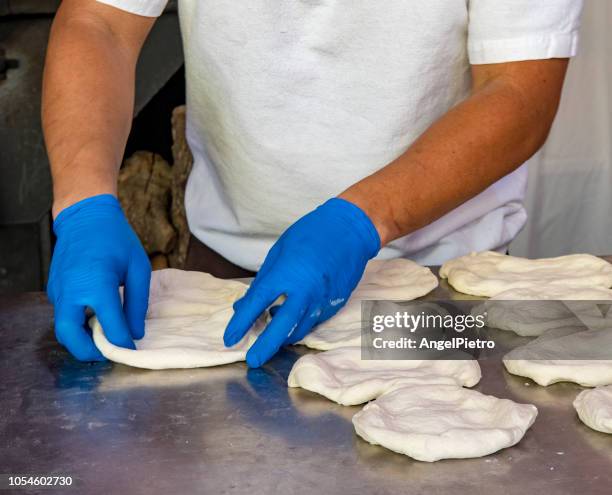 mediterranean food - man kneading "pregnant buns" - blätterteigpastete stock-fotos und bilder
