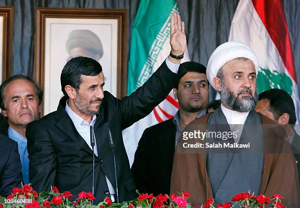 Iranian President Mahmoud Ahmadinejad addresses the crowd while standing next to Nabil Qawouk , a representative for Hezbullah, in south Lebanon,...